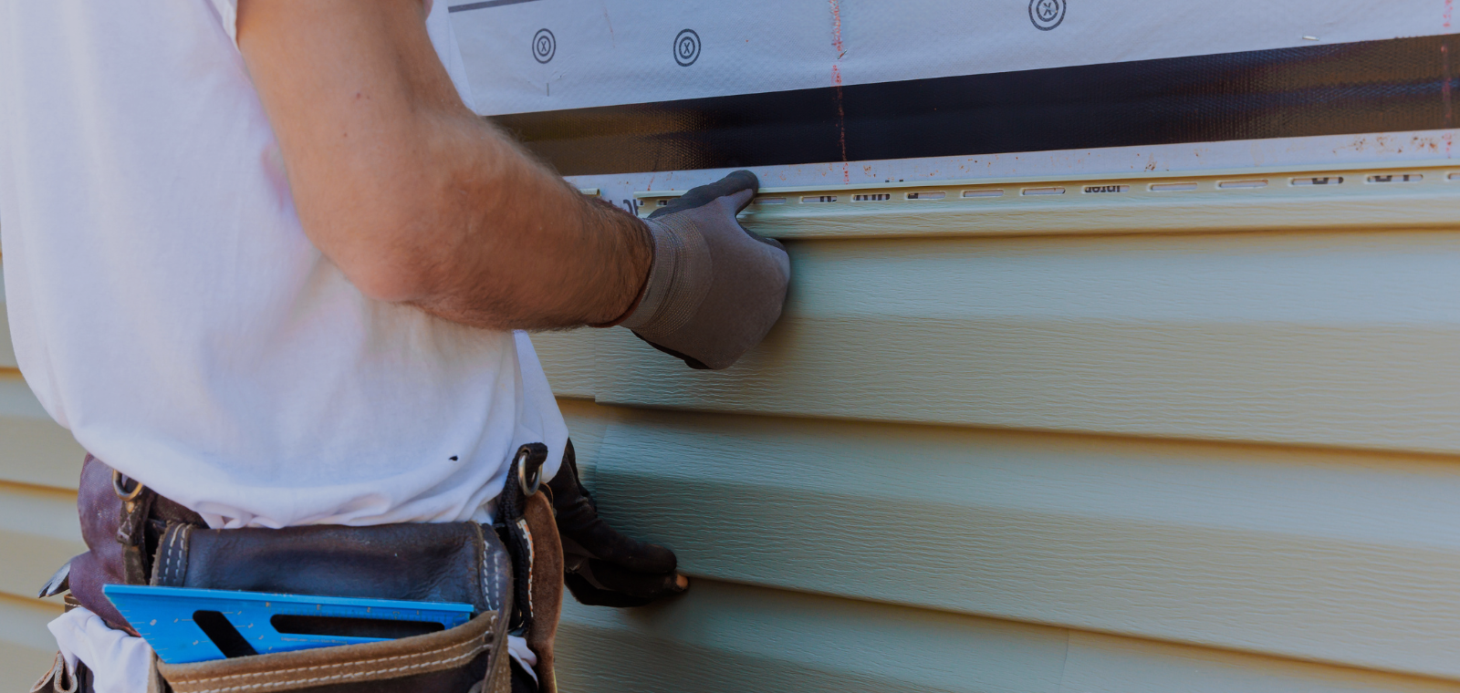 Close-up of vinyl siding panel profiles showing texture and material thickness detail