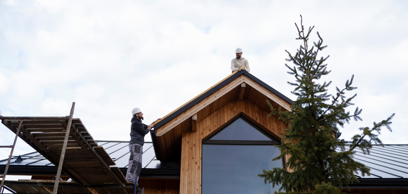 A-American crew installing seamless aluminum gutters on a Southeastern Massachusetts home
