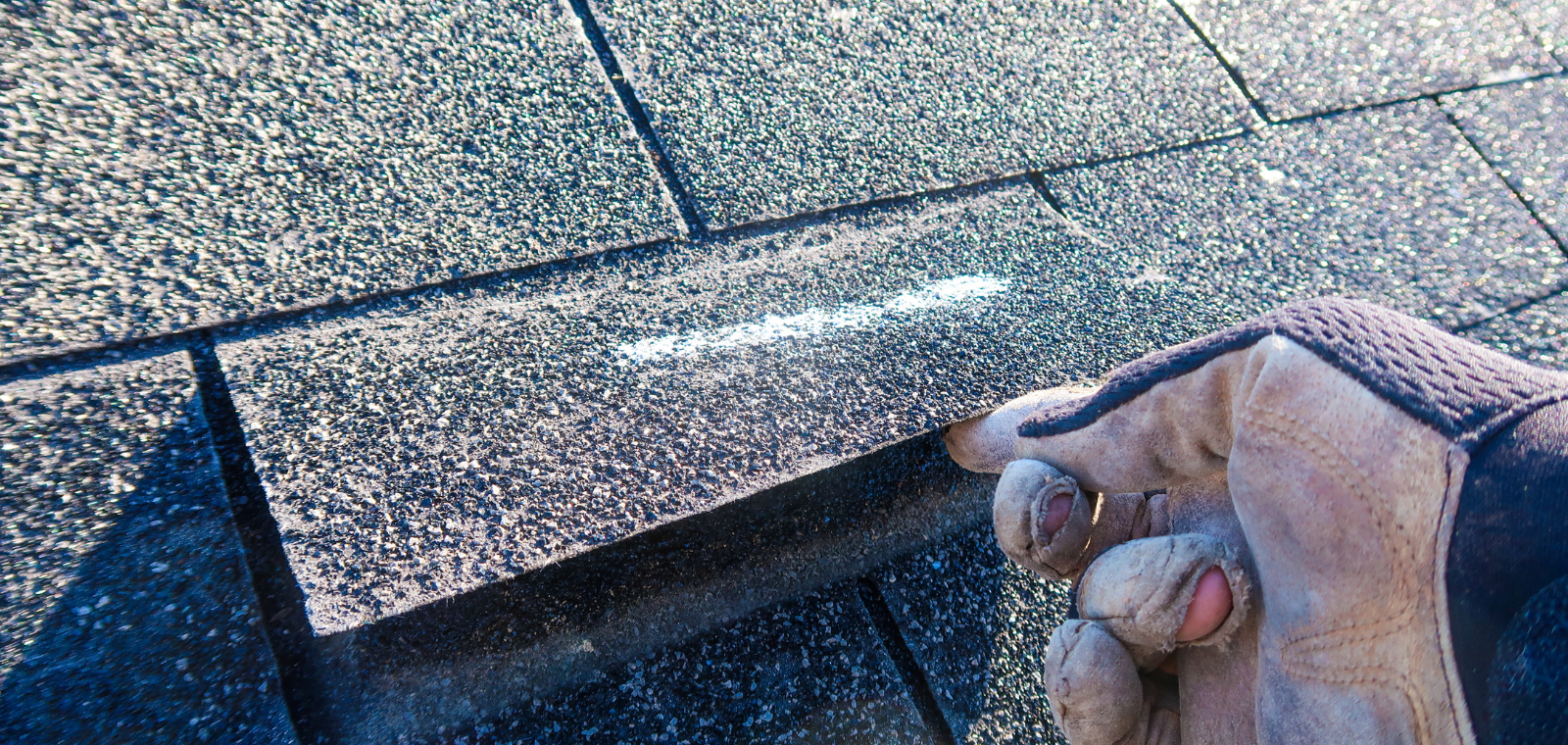 A-American inspector checking shingles and flashing on a Southeastern Massachusetts residential roof