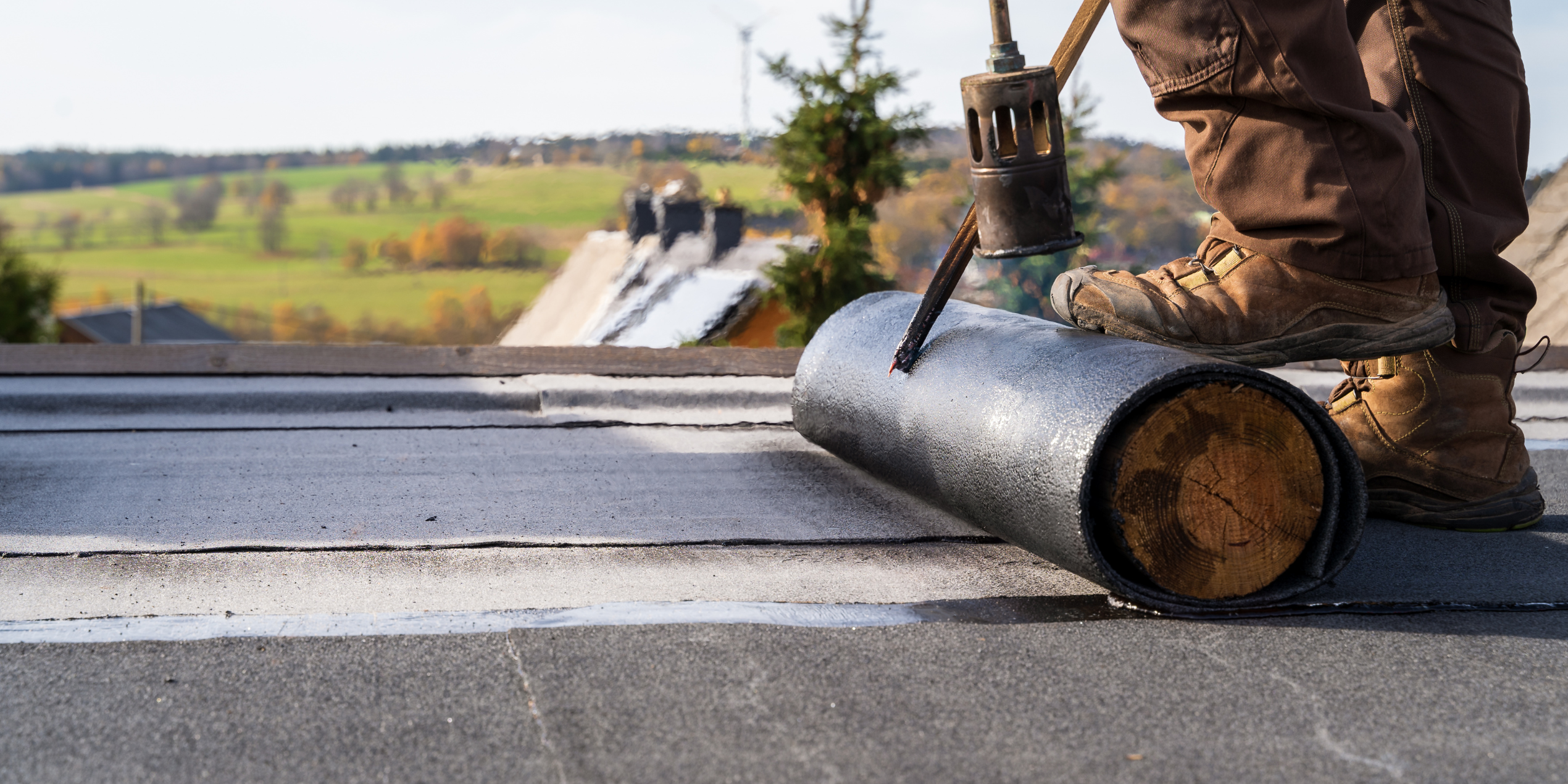 A-American commercial roofing crew working on a large flat roof in Southeastern Massachusetts
